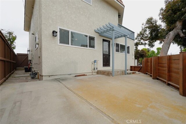 318 S Lucia Ave, Redondo Beach, CA 90277 - rear view of property with stucco siding, a patio area, and a fenced backyard