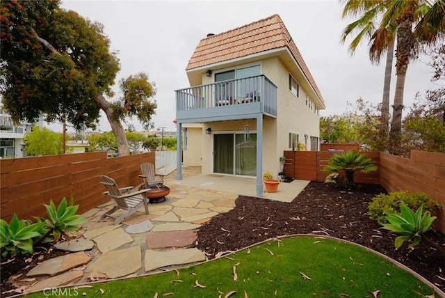 318 S Lucia Ave, Redondo Beach, CA 90277 - rear view of house with a balcony, stucco siding, a tiled roof, a fenced backyard, and a patio