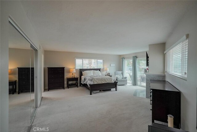 318 S Lucia Ave, Redondo Beach, CA 90277 - bedroom with light colored carpet, a closet, and access to outside