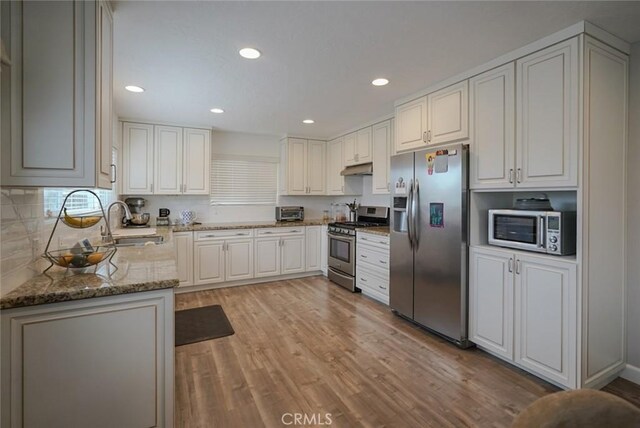 318 S Lucia Ave, Redondo Beach, CA 90277 - kitchen featuring appliances with stainless steel finishes, a sink, light wood-style flooring, light stone countertops, and recessed lighting
