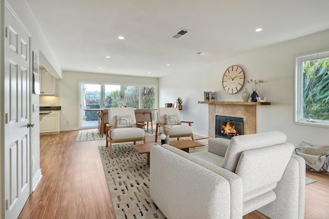 1592 Hawk View Dr, Encinitas, CA 92024 - living area with a fireplace, light wood-type flooring, recessed lighting, and baseboards