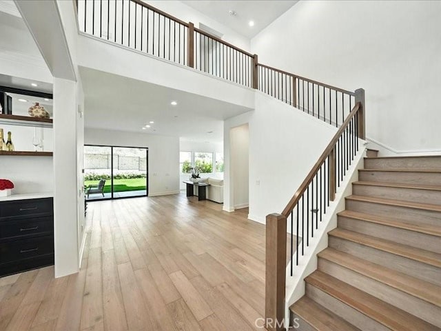 18814 Annmae Pl, Saugus, CA 91350 - stairway featuring wood finished floors, a towering ceiling, and recessed lighting