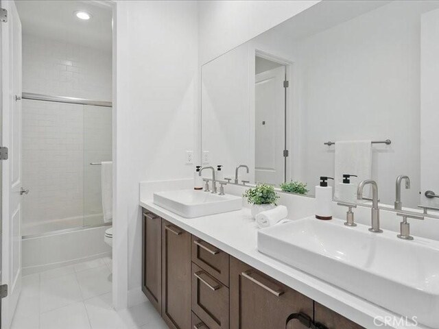 18814 Annmae Pl, Saugus, CA 91350 - bathroom featuring double vanity, enclosed tub / shower combo, tile patterned floors, and recessed lighting