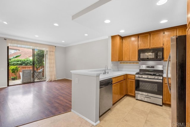 4075 Carmel View Rd Unit 11, San Diego, CA 92130 - kitchen featuring appliances with stainless steel finishes, ornamental molding, a peninsula, light countertops, and brown cabinets