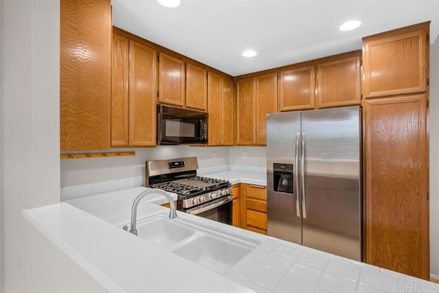 4075 Carmel View Rd Unit 11, San Diego, CA 92130 - kitchen with appliances with stainless steel finishes, brown cabinetry, recessed lighting, and a sink