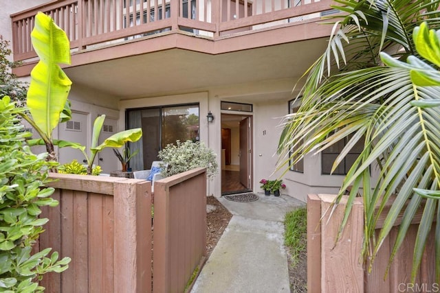 4075 Carmel View Rd Unit 11, San Diego, CA 92130 - view of exterior entry with a balcony and stucco siding