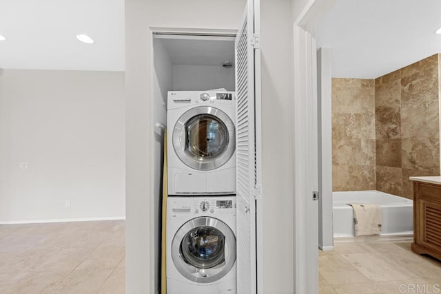 4075 Carmel View Rd Unit 11, San Diego, CA 92130 - laundry room featuring stacked washing machine and dryer, light tile patterned flooring, and recessed lighting