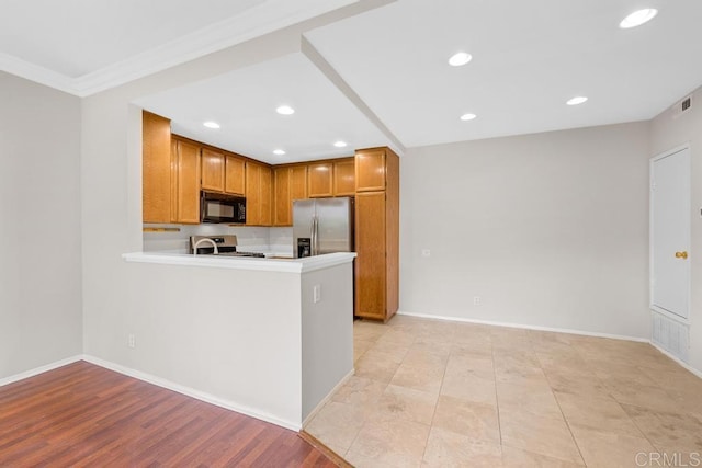 4075 Carmel View Rd Unit 11, San Diego, CA 92130 - kitchen featuring stainless steel appliances, recessed lighting, brown cabinets, a peninsula, and baseboards
