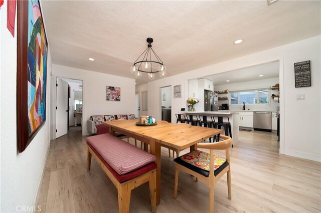 9966 Vernon Ave, Montclair, CA 91763 - dining room featuring light wood-style floors, a chandelier, and recessed lighting