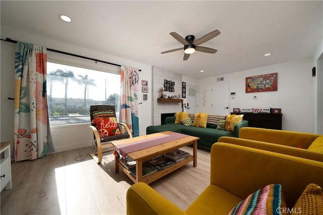 9966 Vernon Ave, Montclair, CA 91763 - living room featuring a ceiling fan, light wood-style floors, recessed lighting, and a tile fireplace