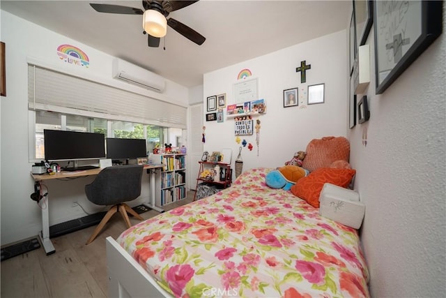 9966 Vernon Ave, Montclair, CA 91763 - bedroom featuring a wall unit AC, wood finished floors, a desk, and ceiling fan