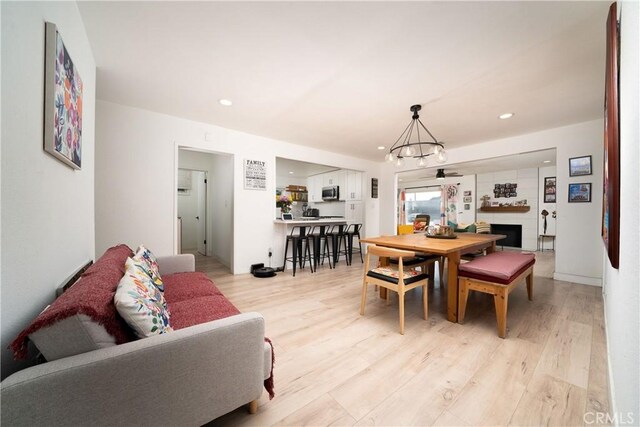 9966 Vernon Ave, Montclair, CA 91763 - dining room featuring light wood-style floors, a fireplace, and recessed lighting