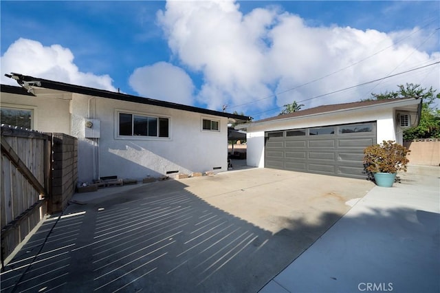 9966 Vernon Ave, Montclair, CA 91763 - view of property exterior featuring stucco siding, a garage, and an outbuilding