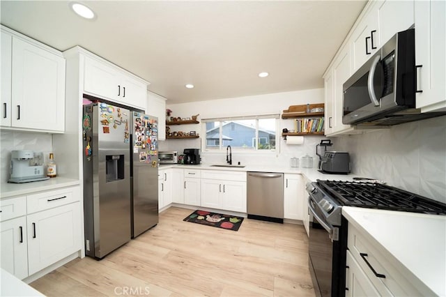 9966 Vernon Ave, Montclair, CA 91763 - kitchen featuring appliances with stainless steel finishes, open shelves, recessed lighting, a sink, and tasteful backsplash