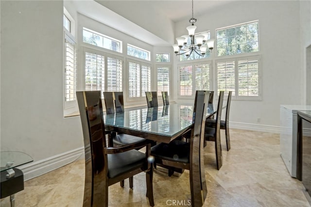 25792 Maple View Dr, Laguna Hills, CA 92653 - dining space featuring a chandelier, a high ceiling, and baseboards