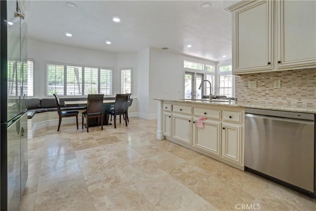 25792 Maple View Dr, Laguna Hills, CA 92653 - kitchen featuring stainless steel appliances, cream cabinetry, a sink, baseboards, and decorative backsplash