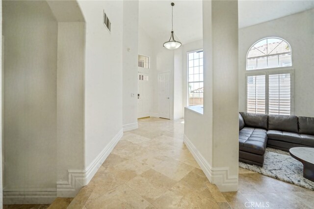25792 Maple View Dr, Laguna Hills, CA 92653 - hall with a high ceiling, baseboards, and arched walkways