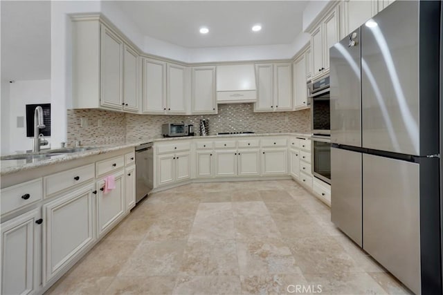 25792 Maple View Dr, Laguna Hills, CA 92653 - kitchen featuring appliances with stainless steel finishes, a sink, tasteful backsplash, light stone countertops, and recessed lighting