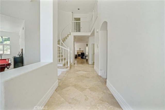 25792 Maple View Dr, Laguna Hills, CA 92653 - hall with a towering ceiling, stairs, baseboards, and arched walkways
