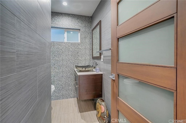 3921 Beverly Glen Blvd, Sherman Oaks, CA 91423 - bathroom featuring toilet, vanity, tile walls, and tile patterned flooring
