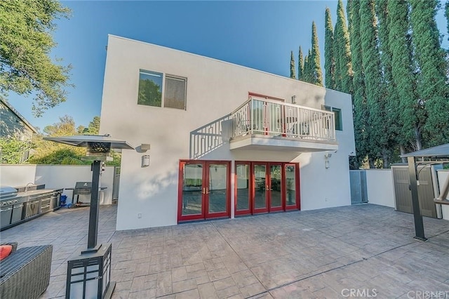 3921 Beverly Glen Blvd, Sherman Oaks, CA 91423 - rear view of property featuring a balcony, stucco siding, a patio, and an outdoor kitchen