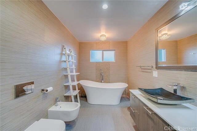 3921 Beverly Glen Blvd, Sherman Oaks, CA 91423 - full bathroom featuring tile walls, vanity, a soaking tub, a bidet, and toilet