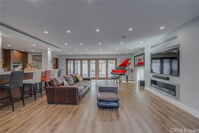 3921 Beverly Glen Blvd, Sherman Oaks, CA 91423 - living room with light wood-style floors, baseboards, recessed lighting, a glass covered fireplace, and french doors