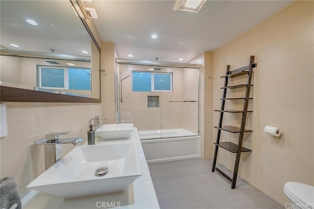 3921 Beverly Glen Blvd, Sherman Oaks, CA 91423 - bathroom featuring toilet, bath / shower combo with glass door, tile walls, recessed lighting, and double vanity