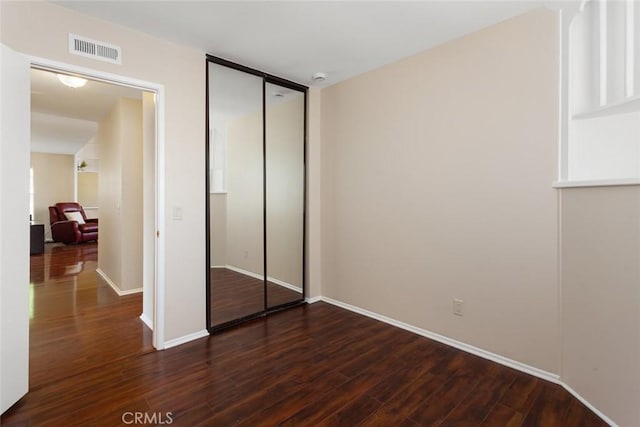 28015 Tupelo Ridge Dr, Valencia, CA 91354 - unfurnished bedroom with dark wood-type flooring, baseboards, and a closet