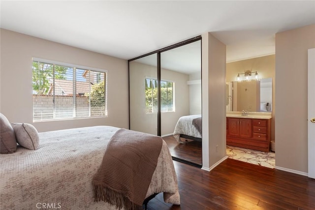 28015 Tupelo Ridge Dr, Valencia, CA 91354 - bedroom with dark wood-style floors, a sink, baseboards, a closet, and connected bathroom