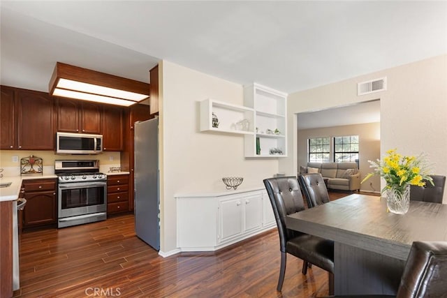 28015 Tupelo Ridge Dr, Valencia, CA 91354 - kitchen featuring stainless steel appliances, light countertops, and dark wood finished floors