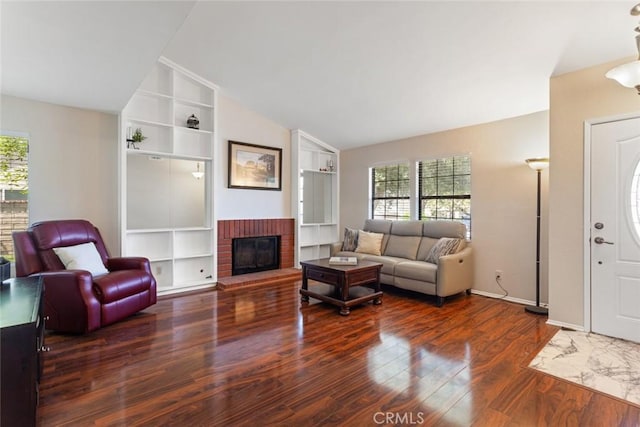 28015 Tupelo Ridge Dr, Valencia, CA 91354 - living area with wood finished floors, built in features, lofted ceiling, a fireplace, and baseboards