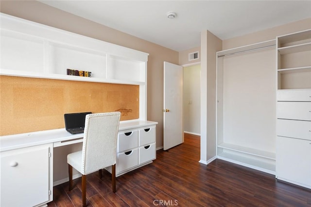 28015 Tupelo Ridge Dr, Valencia, CA 91354 - home office featuring dark wood-type flooring, built in desk, and baseboards