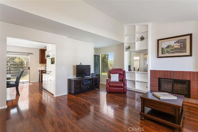 28015 Tupelo Ridge Dr, Valencia, CA 91354 - living area with wood finished floors, a fireplace, built in shelves, and baseboards