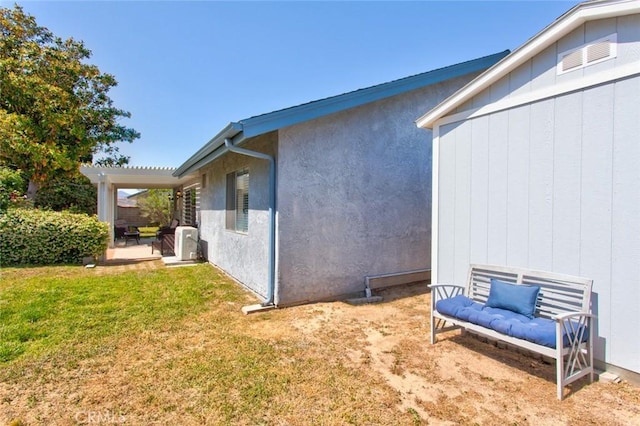 28015 Tupelo Ridge Dr, Valencia, CA 91354 - view of side of home featuring a patio, a lawn, and stucco siding