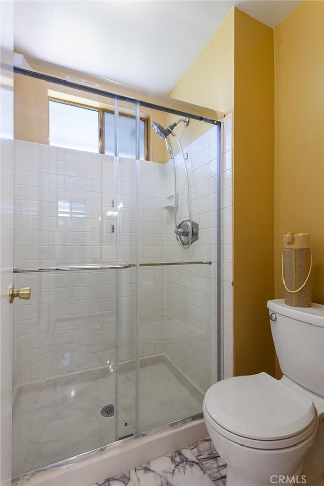 28015 Tupelo Ridge Dr, Valencia, CA 91354 - bathroom featuring toilet, a stall shower, and marble look tiles