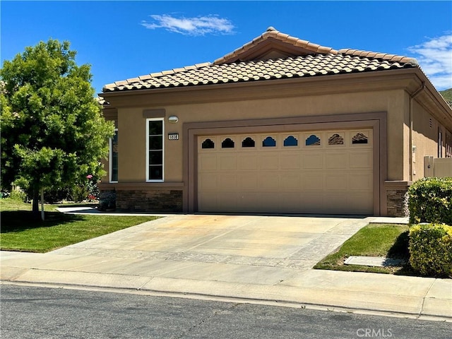 5836 Indian Canyon Dr, Banning, CA 92220 - view of front facade featuring stone siding, an attached garage, stucco siding, and a tiled roof