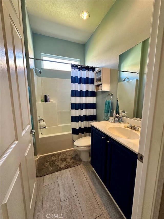5836 Indian Canyon Dr, Banning, CA 92220 - full bathroom featuring vanity, toilet, shower / bath combination with curtain, wood finished floors, and a textured ceiling