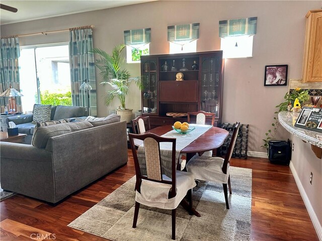 5836 Indian Canyon Dr, Banning, CA 92220 - dining space featuring dark wood-style floors and baseboards