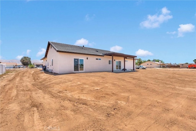 22212 Lone Eagle Rd, Apple Valley, CA 92308 - rear view of property featuring stucco siding, a tiled roof, and a patio