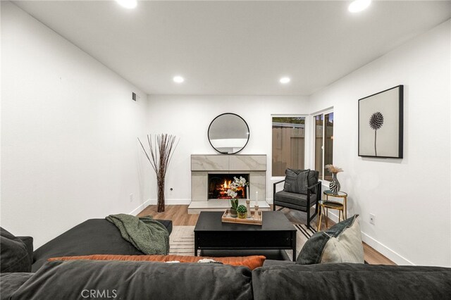 12573 Brickellia St, San Diego, CA 92129 - living area with wood finished floors, recessed lighting, a fireplace, and baseboards