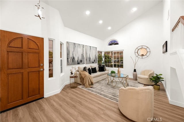 12573 Brickellia St, San Diego, CA 92129 - living room with high vaulted ceiling, light wood-style floors, recessed lighting, and baseboards