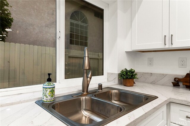 12573 Brickellia St, San Diego, CA 92129 - kitchen view of a sink, white cabinets, and light stone countertops