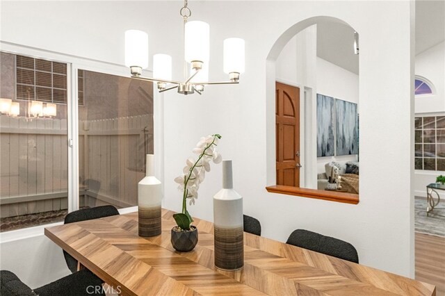 12573 Brickellia St, San Diego, CA 92129 - dining area with a chandelier and arched walkways
