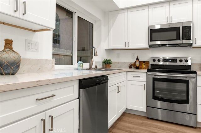 12573 Brickellia St, San Diego, CA 92129 - kitchen with appliances with stainless steel finishes, a sink, and white cabinetry