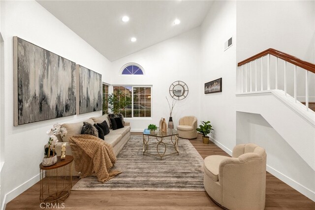 12573 Brickellia St, San Diego, CA 92129 - living room with stairway, recessed lighting, high vaulted ceiling, baseboards, and wood finished floors