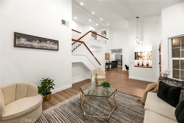 12573 Brickellia St, San Diego, CA 92129 - living room featuring stairs, baseboards, high vaulted ceiling, wood finished floors, and recessed lighting