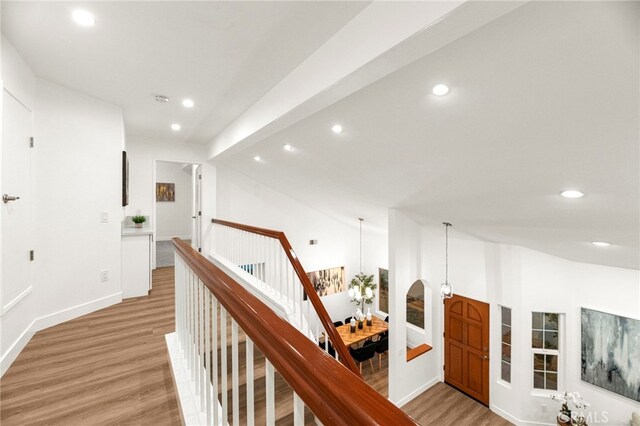 12573 Brickellia St, San Diego, CA 92129 - hallway with light wood finished floors, an upstairs landing, recessed lighting, a chandelier, and baseboards