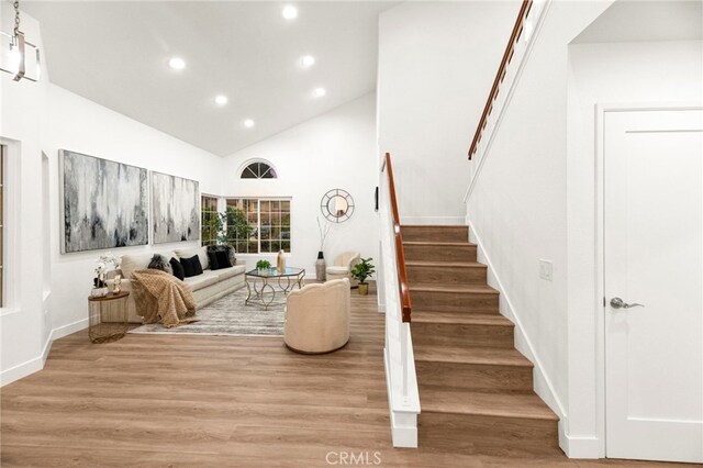 12573 Brickellia St, San Diego, CA 92129 - living area featuring stairway, recessed lighting, light wood-style floors, high vaulted ceiling, and baseboards