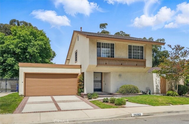 25263 Via Sistine, Valencia, CA 91355 - view of front facade with stucco siding, concrete driveway, and an attached garage